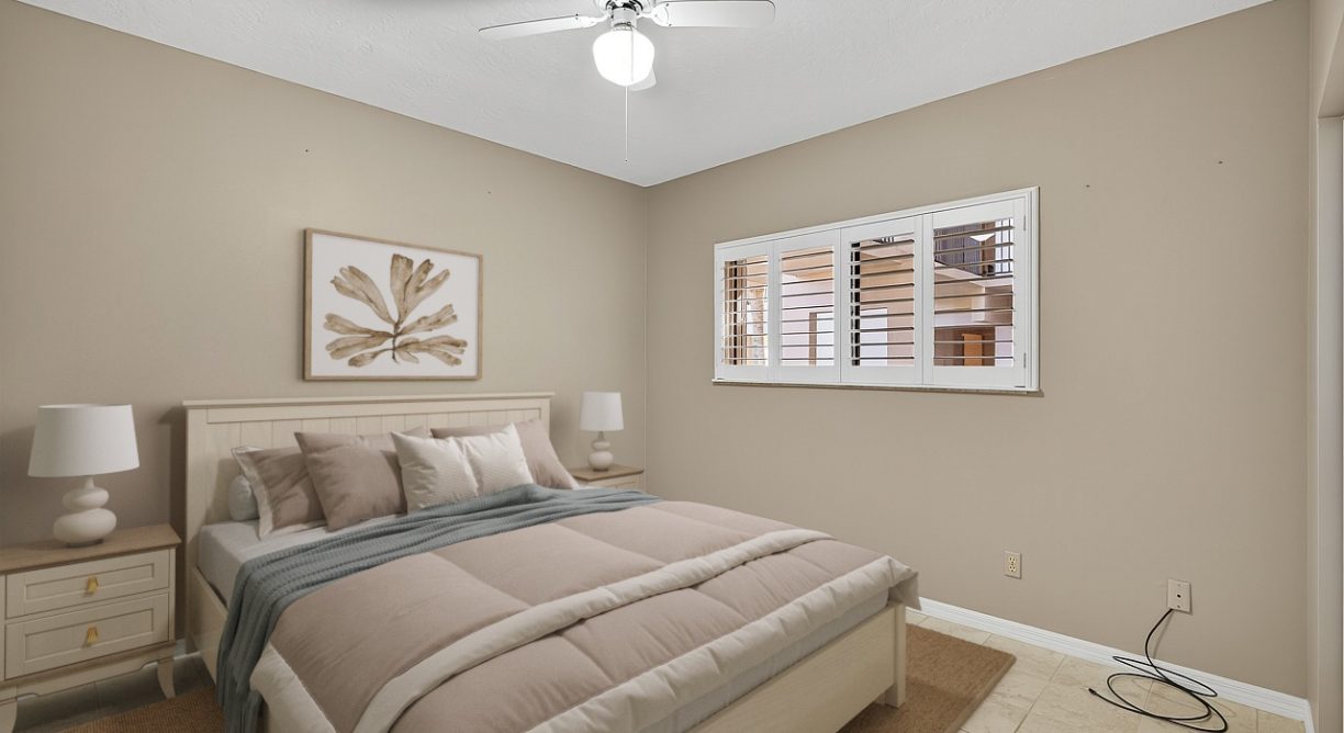 Staged bedroom photo of waterfront condo for sale at 6165 S Mirror Lake Drive #106 Sebastian, FL 32958